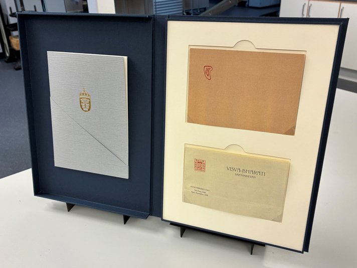 The box open, revealing the papers.