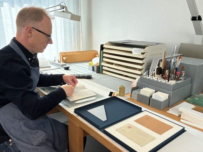A conservator is working on the gift.