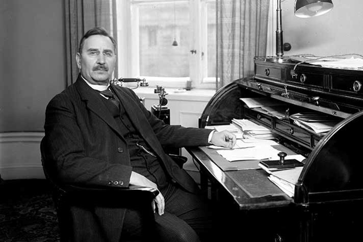 Carl Gustaf Ekman at a desk in an office room.