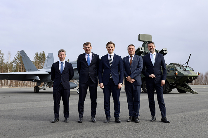 The nordic defence ministers standing  next to each outside. 