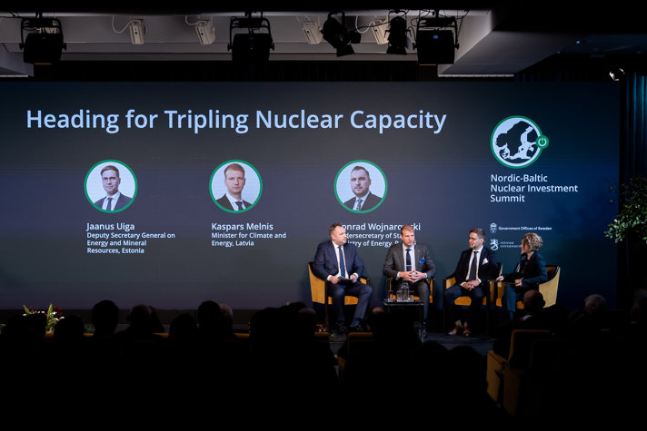 Three ministers sitting down in armchairs having a discussion with the moderator