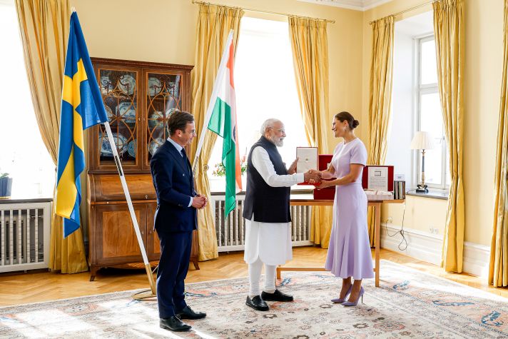 Prime Minister Modi shakes hands with the Crown Princess. Ulf Kristersson is standing to the left of them.