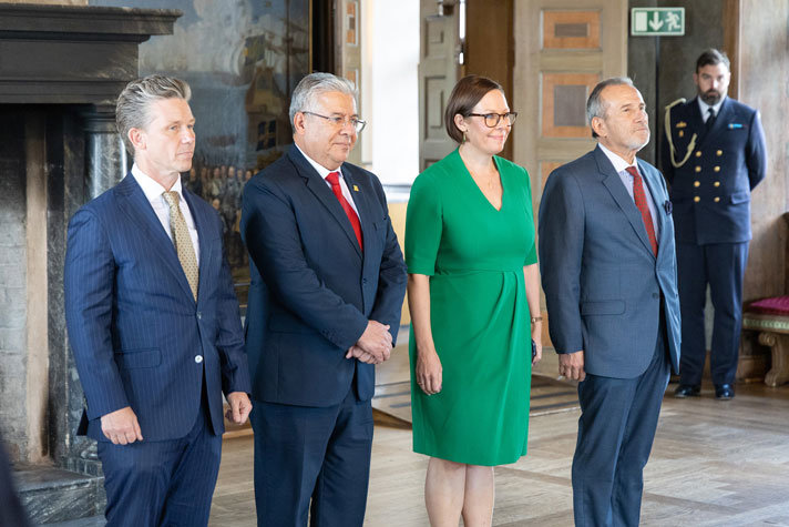 The ministers standing in line inside the palace.
