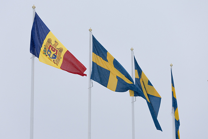 The flag of the Republic of Moldava and the flag of Sweden. 