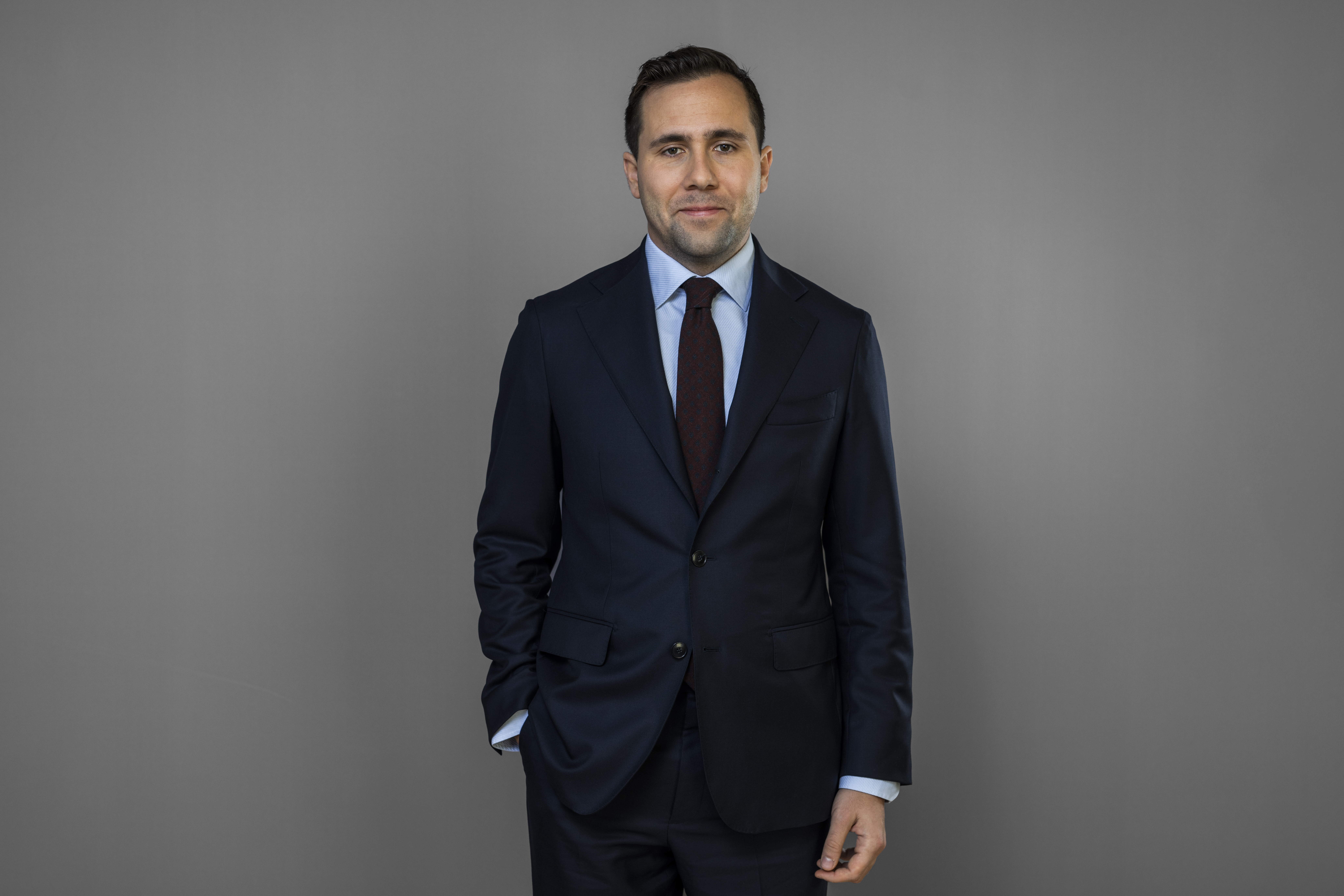 Smiling man in a navy blue suit