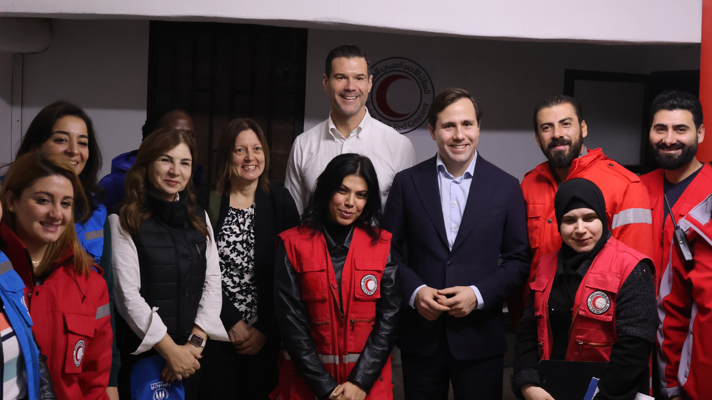 Minister for Migration Johan Forssell and Minister for International Development Cooperation and Foreign Trade Benjamin Dousa pose with workers from UNHCR and the Syrian Red Crescent and women who have returned to Syria.