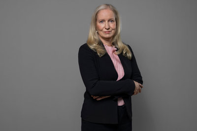 Half-length portrait of Anna Dahlberg against a grey background.