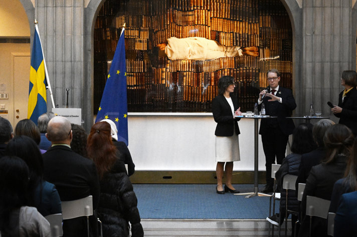 Billström and Roswall standing in front of the audience - speaking in a microphone