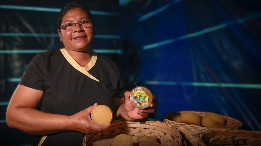 Woman holding shampoo products.