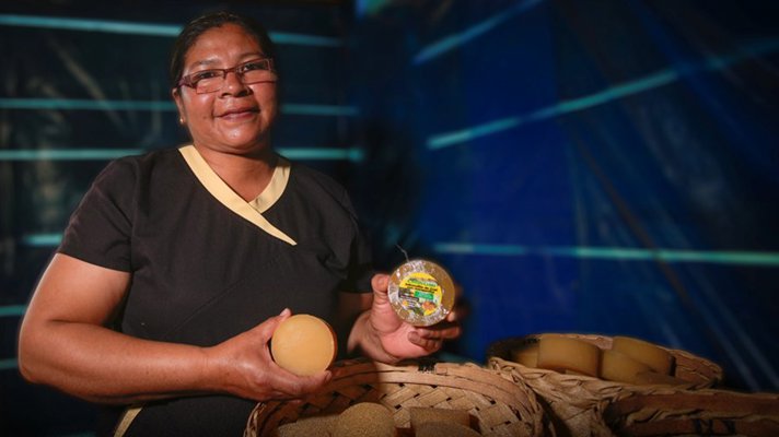 Woman holding shampoo products.